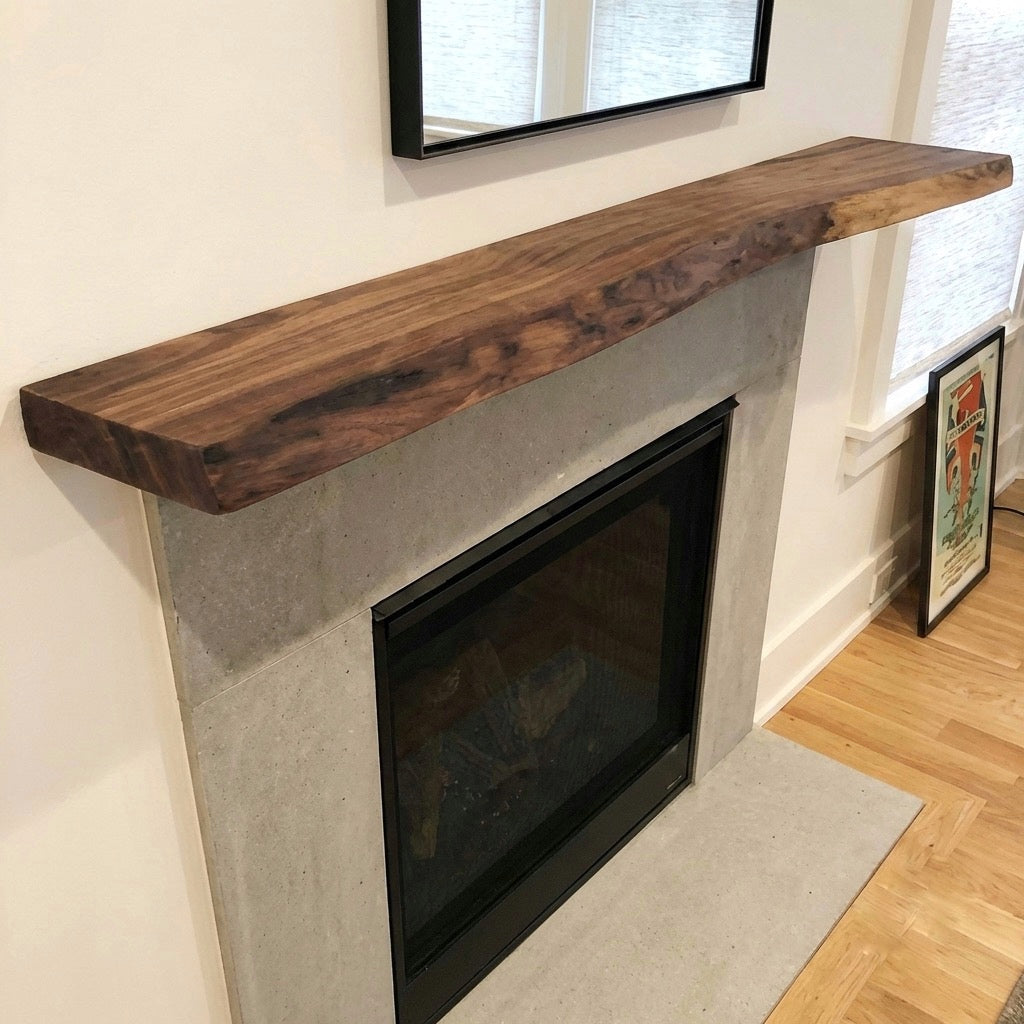 Modern fireplace with wooden mantel and concrete base