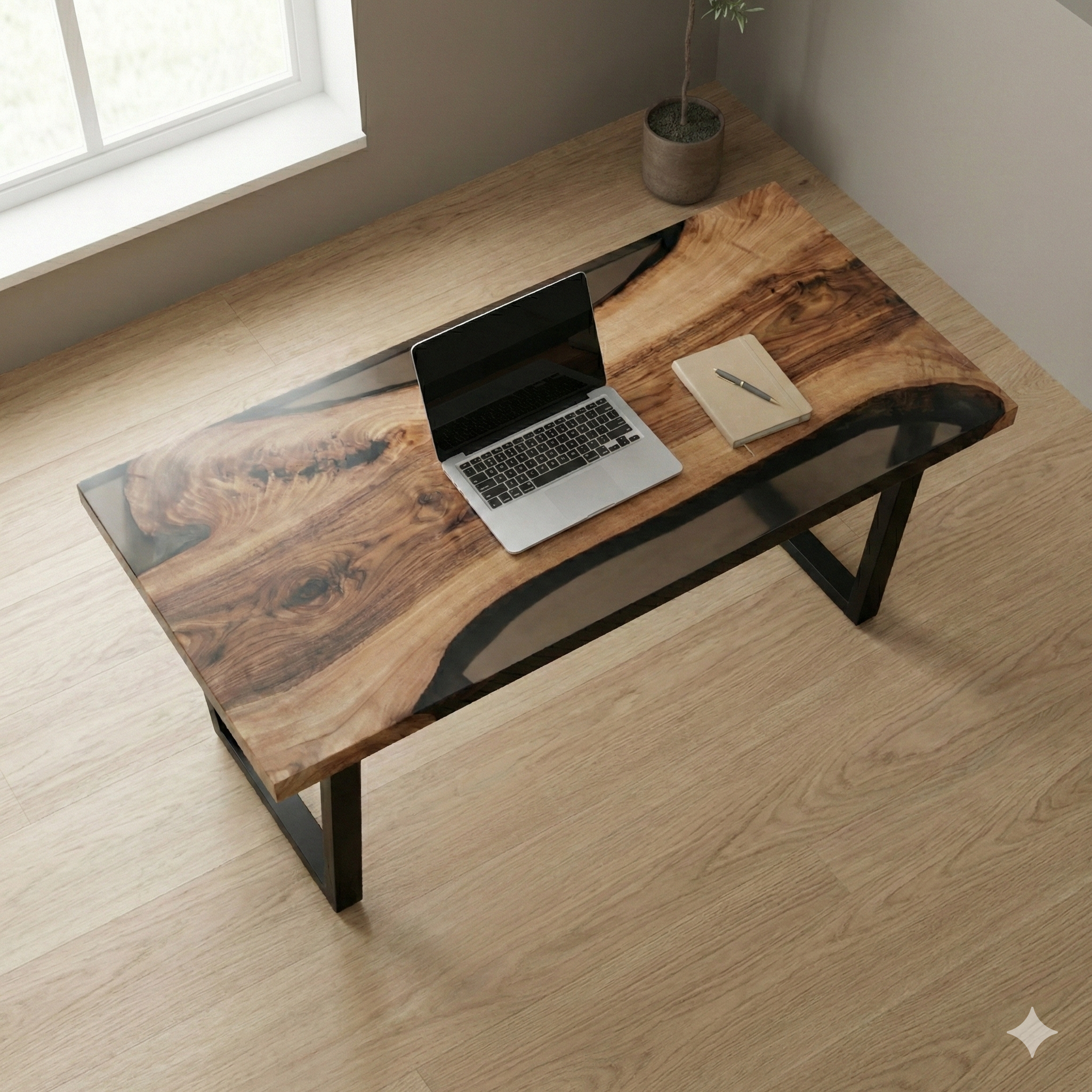 Wooden desk with laptop and notebook in a room with a window.