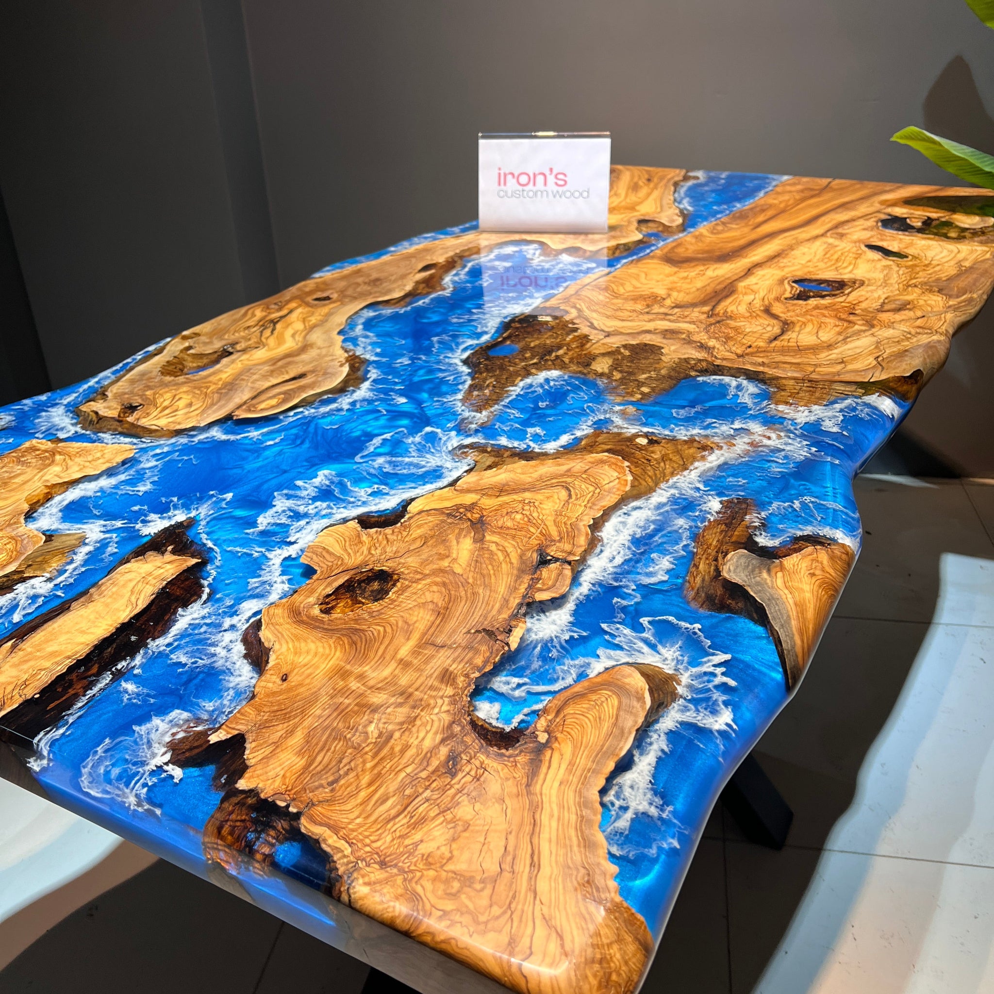 Table with blue resin and wood design on a gray surface